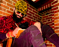 Nevv Evve writing in a notebook during a late-night creative songwriting session while wearing The North Face artistic fashion and designer accessories.