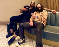 Nevv Evve wearing his Balenciaga sweater and Rick Owens shoes and manager iwill1Time wearing his Louis Vuitton shoes relaxing inside a luxury music studio during an exclusive artist development and custom creative direction session.