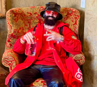 Alternative pop artist Nevv Evve wearing luxury designer attire while discussing creative ideas and personalized songwriting concepts during a custom song consultation experience.